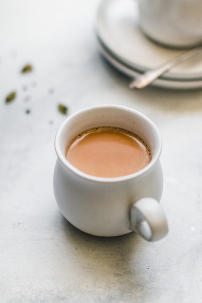 a cup of coffee sitting next to a cup of coffee