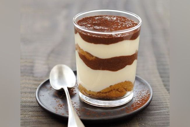 a cup of coffee sitting on top of a wooden table